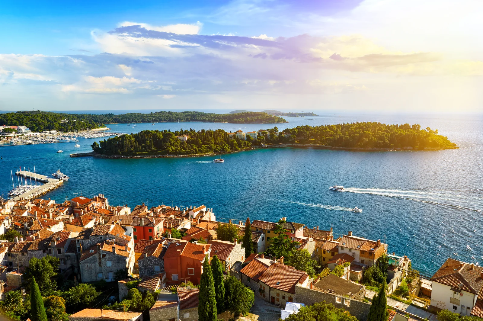 Rovinj old town rooftops and offshore islands at sunset