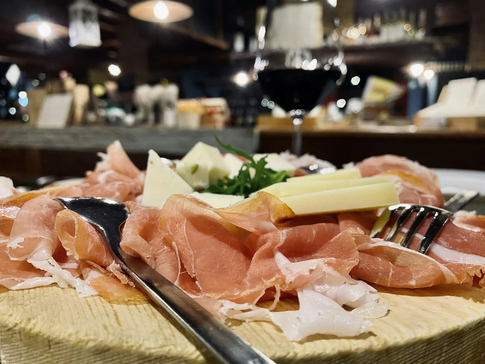 Board of Istrian pršut and cheese with a glass of red wine