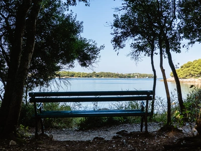 Shaded bench with a sea view at Škaraba