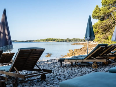 Sun loungers and parasols at Škaraba