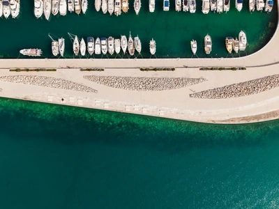 Curved marina breakwater with stone wave pattern