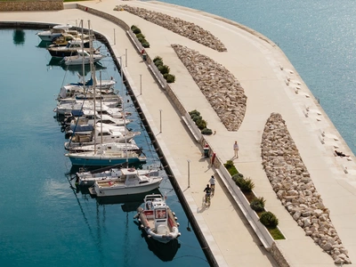 Marina promenade with cyclists on the breakwater