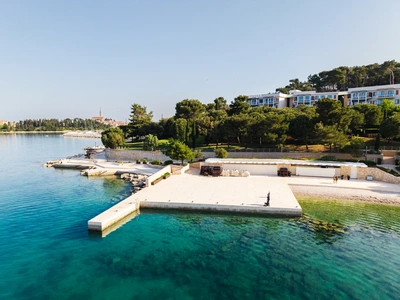 Concrete swim platform with deck chairs
