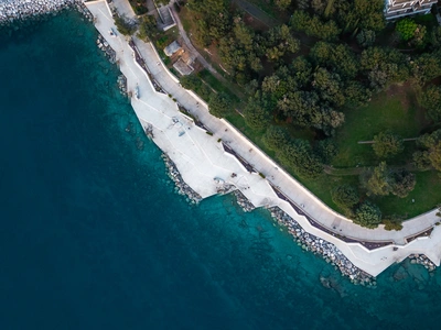 Top-down view of the promenade curving along the shore