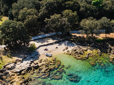 Secluded cove with a small boat on the pebbles