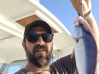 Captain Mati with an amberjack on a Rovinj fishing charter — Rovinj